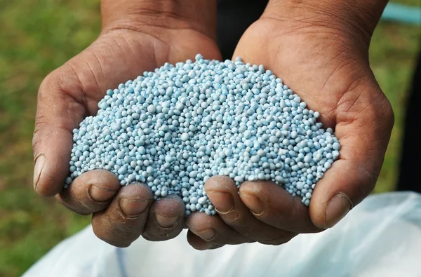 depositphotos_73839473-stock-photo-hands-holding-artificial-fertilizer